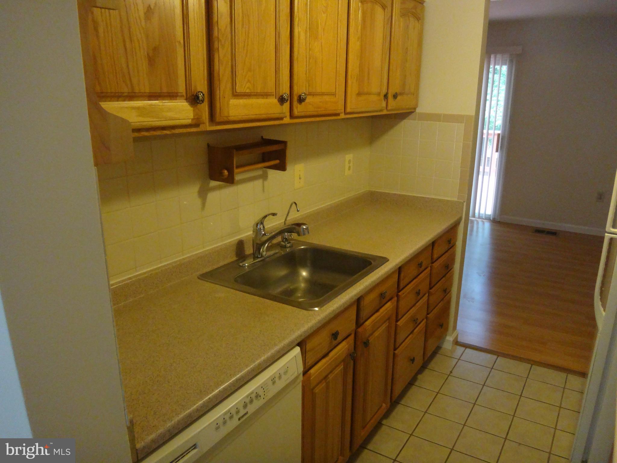6446 Shannon Station Court Springfield, VA 22152 - Photo 2 of 25 a bathroom with a sink and a washing machine