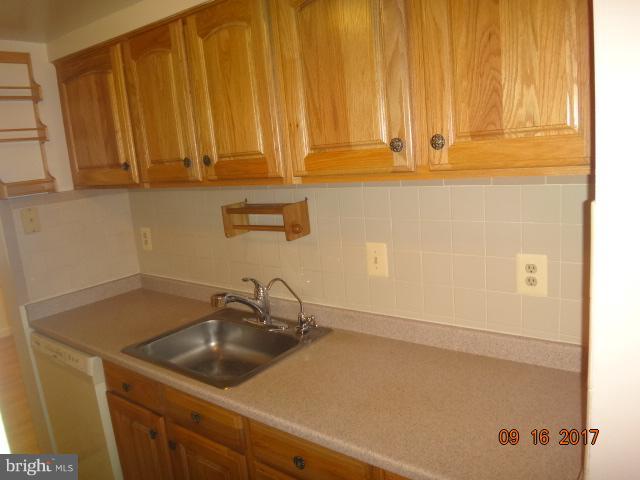 6446 Shannon Station Court Springfield, VA 22152 - Photo 4 of 25 a bathroom with a sink and cabinets