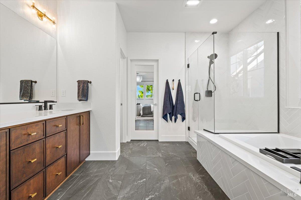 1469 Oak Circle Rohnert Park, CA 94928 - Photo 21 of 42 Spa-Inspired Luxury Featuring dual vanities, a freestanding soaking tub, oversized walk-in shower, designer lighting, and elegant finishes, the primary bath was designed to feel like a boutique hotel retreat.