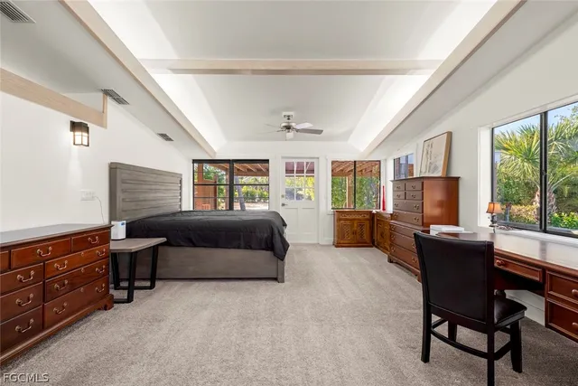 a bedroom with furniture and a flat screen tv