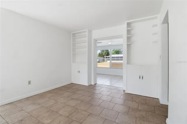 a view of an empty room and a window