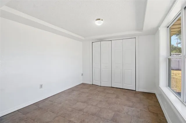 a view of an empty room and a window