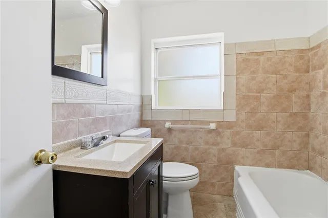 a bathroom with a sink a toilet and a bathtub