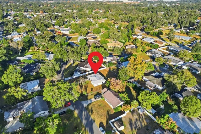 an aerial view of a houses with yard