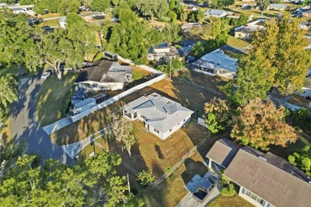 an aerial view of a house with a yard and garden