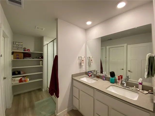 a bathroom with a double vanity sink and a mirror
