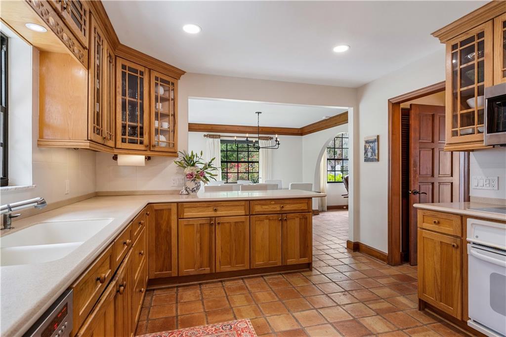 246 Live Oak Road Vero Beach, FL 32963 - Photo 16 of 30 a kitchen with stainless steel appliances granite countertop a sink and cabinets