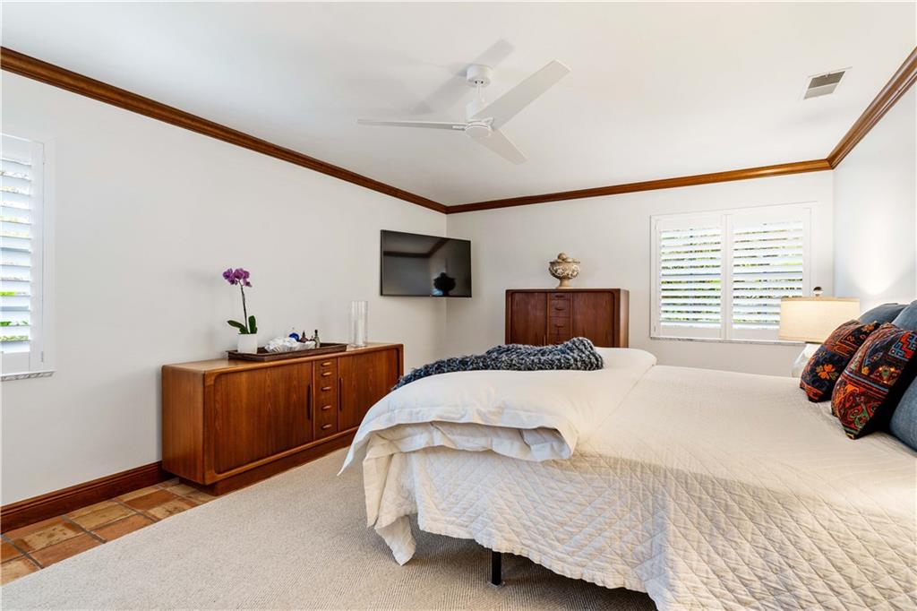 246 Live Oak Road Vero Beach, FL 32963 - Photo 18 of 30 a bedroom with a bed and wooden floor