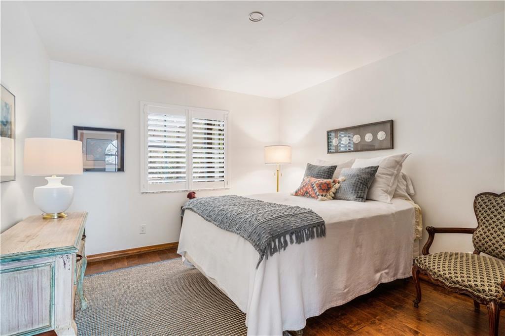 246 Live Oak Road Vero Beach, FL 32963 - Photo 23 of 30 a bedroom with a bed and wooden floor