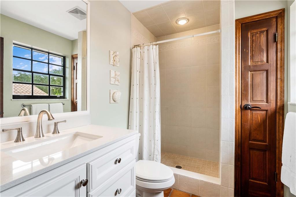 246 Live Oak Road Vero Beach, FL 32963 - Photo 28 of 30 a bathroom with a granite countertop sink toilet and shower