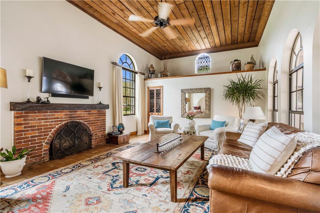 246 Live Oak Road Vero Beach, FL 32963 - Photo 9 of 30 a living room with furniture a fireplace and a flat screen tv