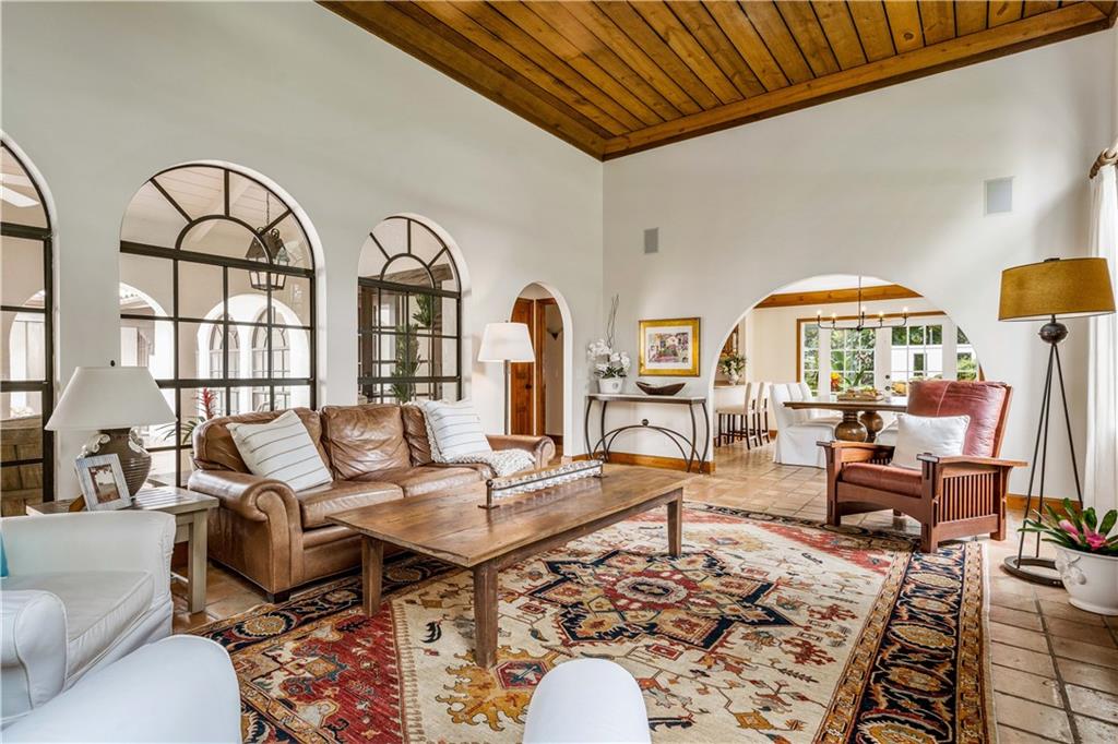 246 Live Oak Road Vero Beach, FL 32963 - Photo 10 of 30 a living room with furniture a chandelier and a dining table