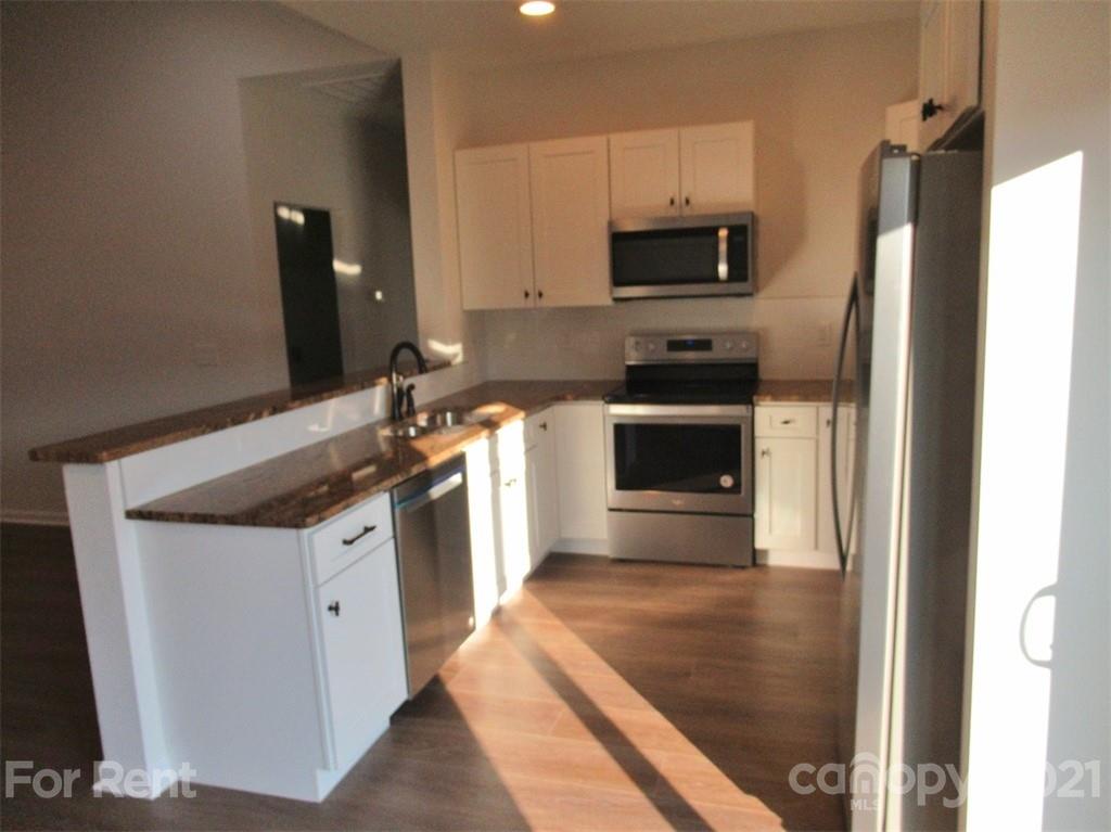 1544 Null Road Lincolnton, NC 28092 - Photo 8 of 22 a kitchen with granite countertop a stove and a refrigerator