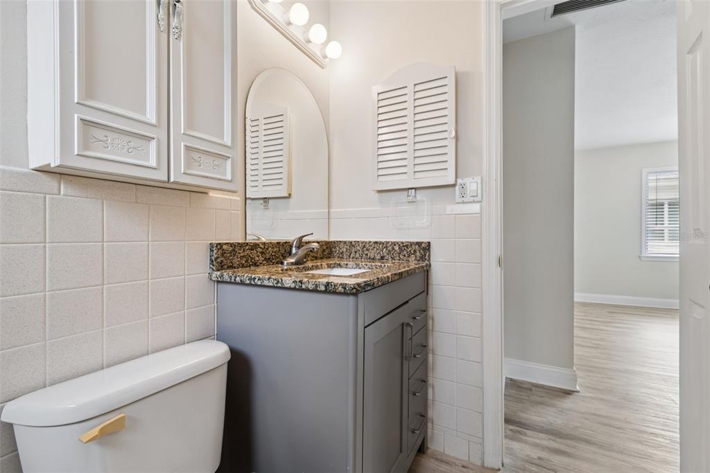 6026 Lilli Way Bradenton, FL 34207 - Photo 14 of 62 a bathroom with a granite countertop sink and a toilet