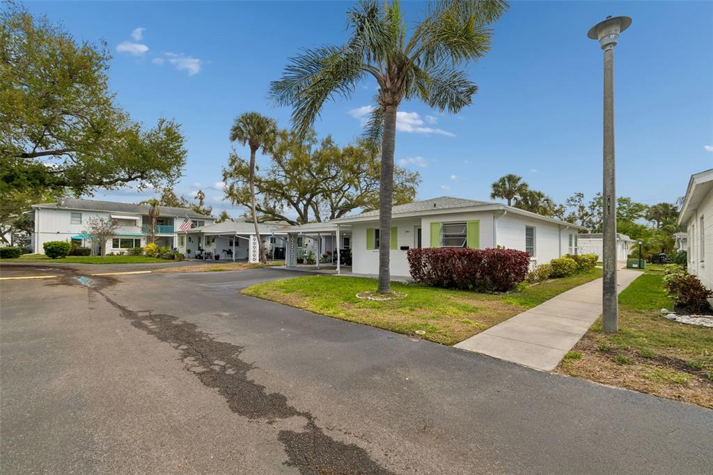6026 Lilli Way Bradenton, FL 34207 - Photo 2 of 62 a front view of a house with a yard and palm trees