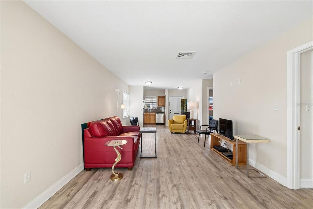 6026 Lilli Way Bradenton, FL 34207 - Photo 25 of 62 a living room with furniture a flat screen tv and a wooden floor