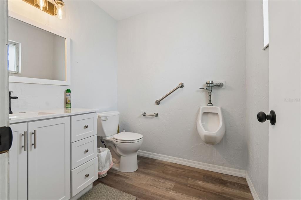 6026 Lilli Way Bradenton, FL 34207 - Photo 33 of 62 a bathroom with a toilet sink a mirror and vanity