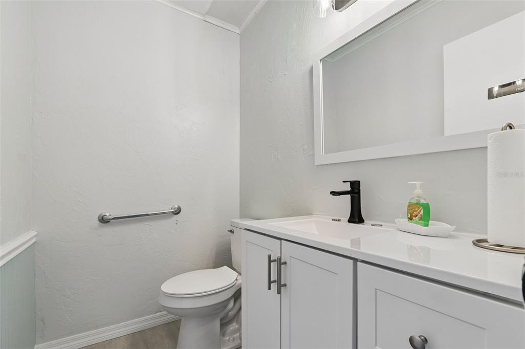 6026 Lilli Way Bradenton, FL 34207 - Photo 37 of 62 a bathroom with a sink a toilet and a mirror