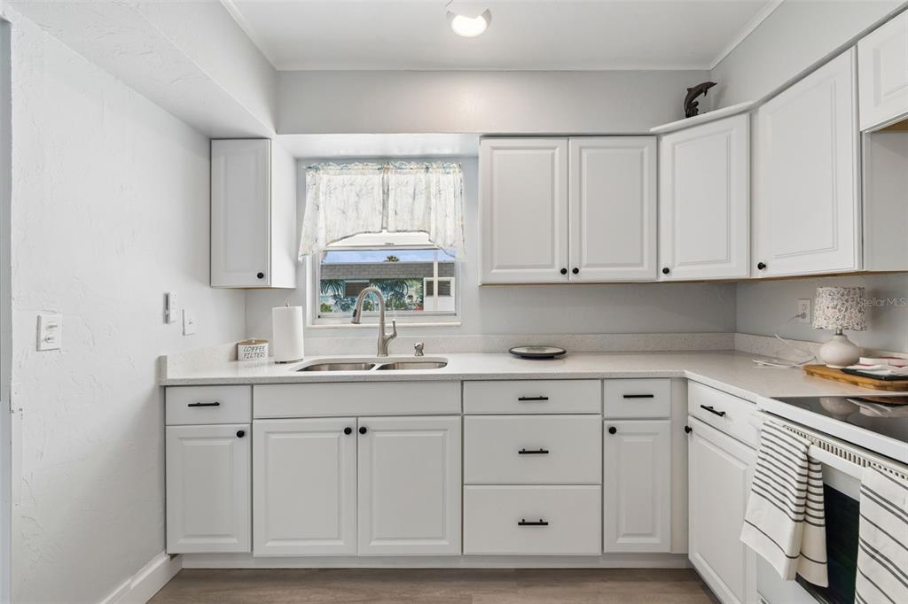 6026 Lilli Way Bradenton, FL 34207 - Photo 40 of 62 a kitchen with white cabinets and sink