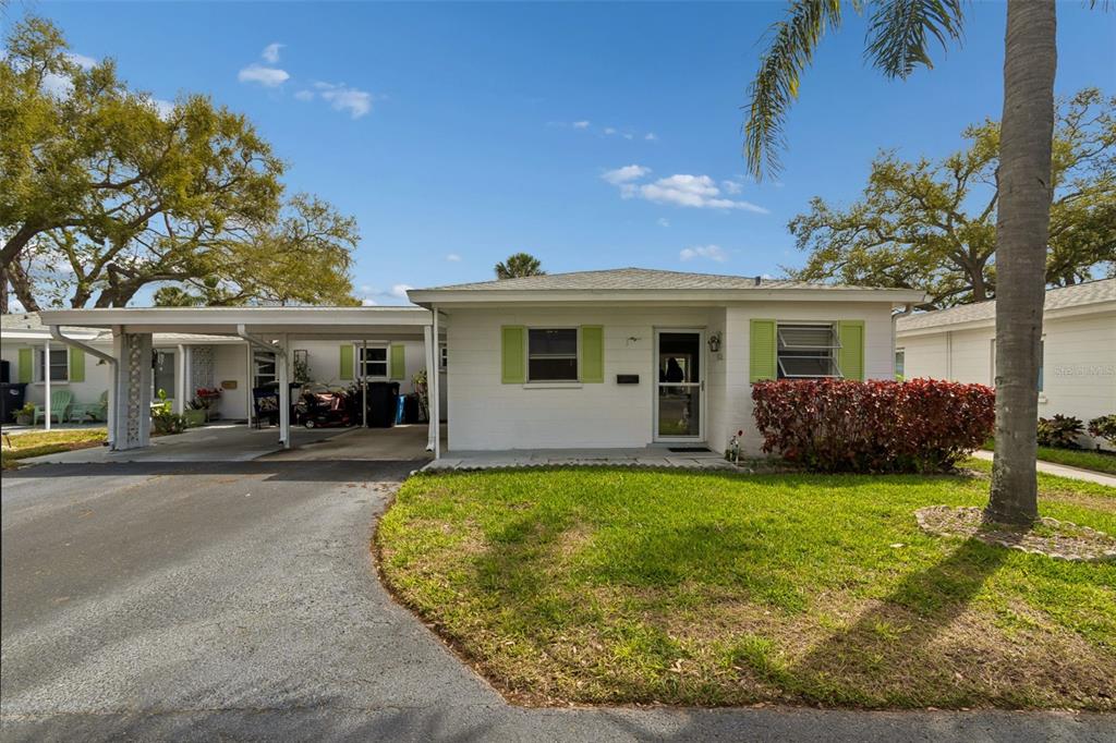 6026 Lilli Way Bradenton, FL 34207 - Photo 4 of 62 a view of a house with a yard and potted plants