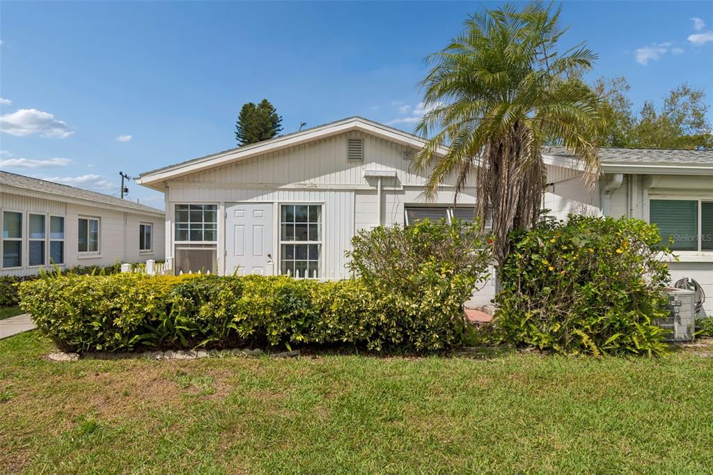 6026 Lilli Way Bradenton, FL 34207 - Photo 6 of 62 a front view of a house with a garden