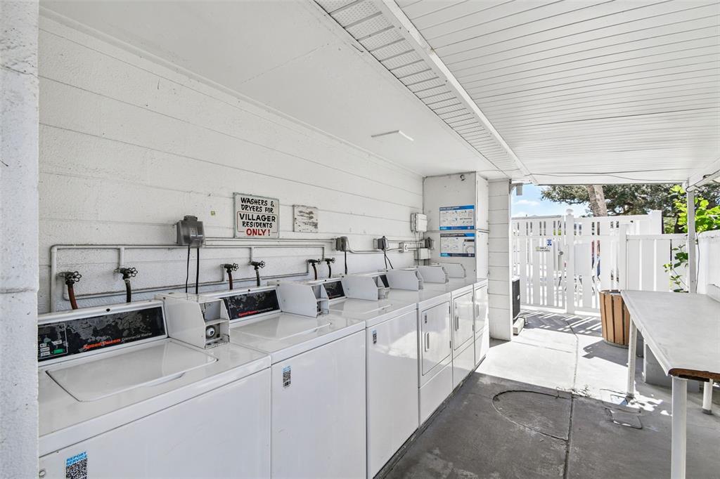 6026 Lilli Way Bradenton, FL 34207 - Photo 62 of 62 a large white kitchen with stainless steel appliances granite countertop a sink and cabinets