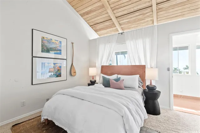 a bedroom with a large bed and a painting on the wall