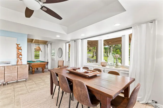 a view of a dining room and livingroom with furniture window and wooden floor