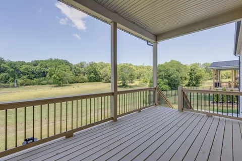 a view of balcony with wooden floor