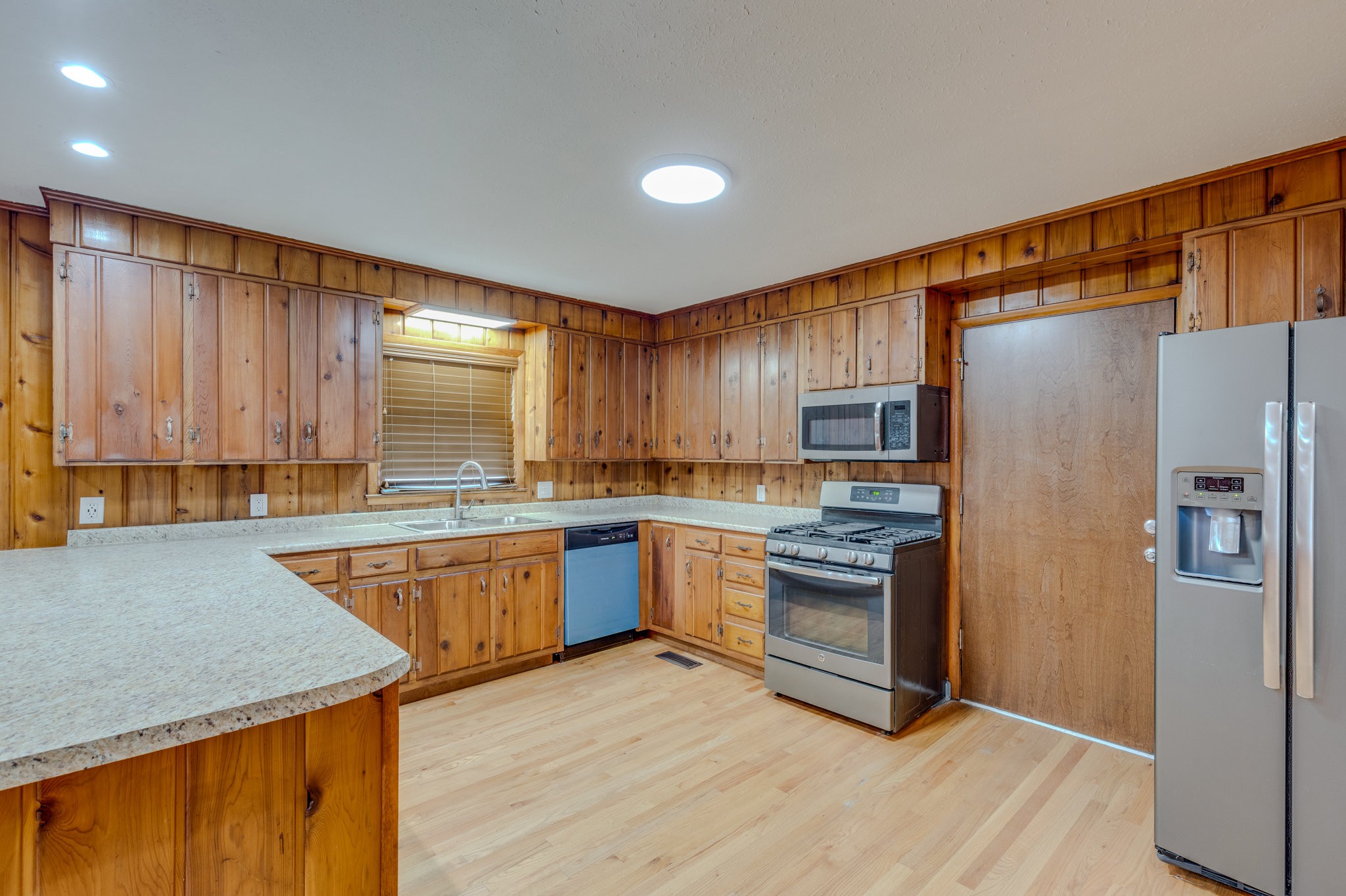 102 Sunset Drive Pulaski, TN 38478 - Photo 11 of 37 a kitchen with stainless steel appliances granite countertop a refrigerator a sink dishwasher a stove with wooden cabinets and floor