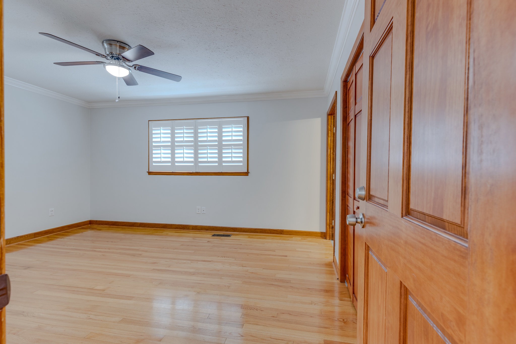 102 Sunset Drive Pulaski, TN 38478 - Photo 14 of 37 an empty room with wooden floor fan and windows