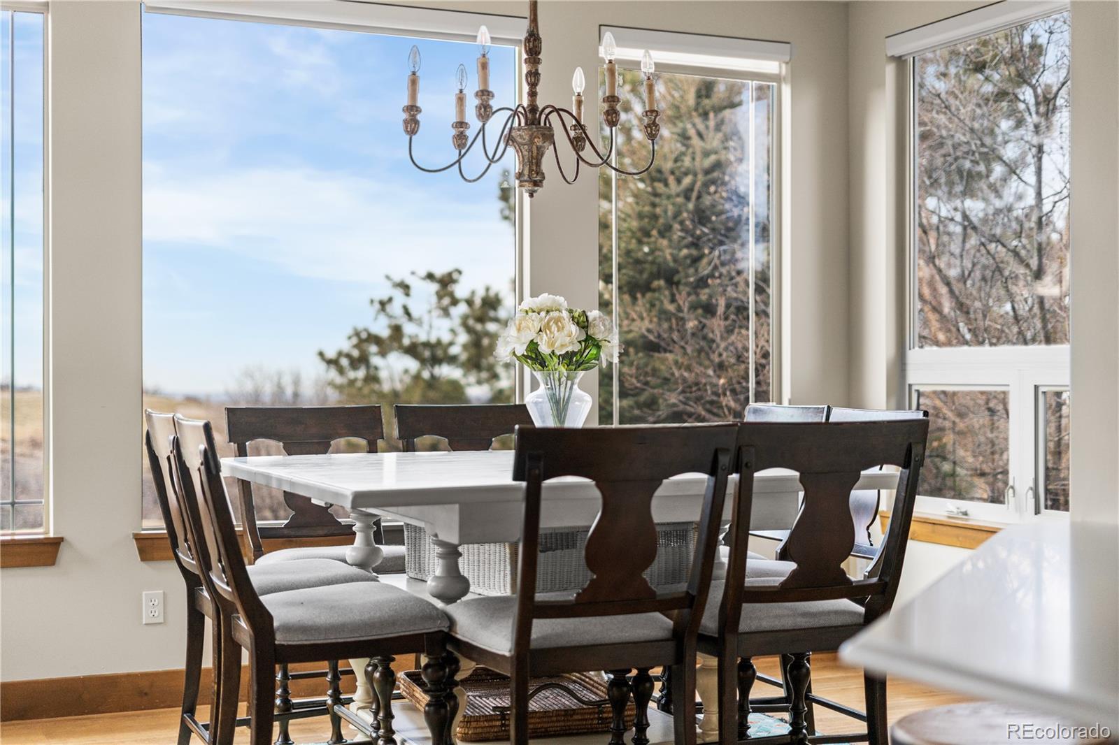 1251 Buffalo Ridge Road Castle Pines, CO 80108 - Photo 14 of 50 a view of a dining room with furniture window and wooden floor