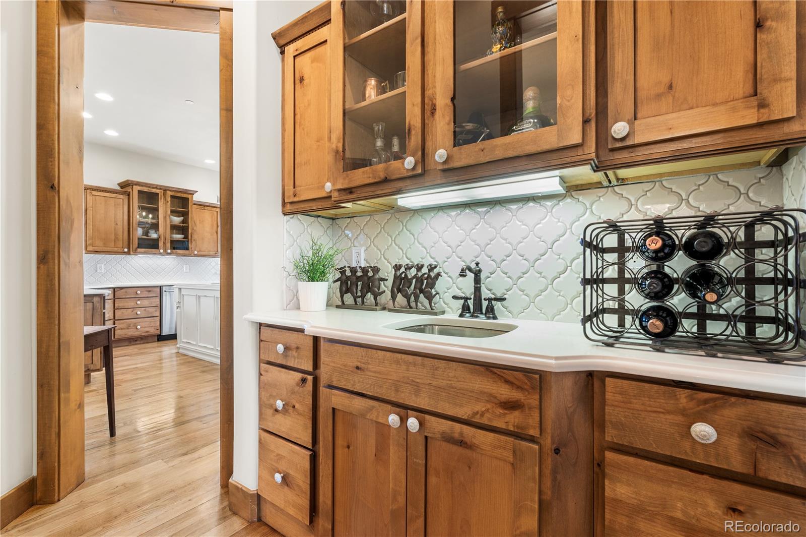 1251 Buffalo Ridge Road Castle Pines, CO 80108 - Photo 15 of 50 a kitchen with stainless steel appliances granite countertop a sink and a cabinets