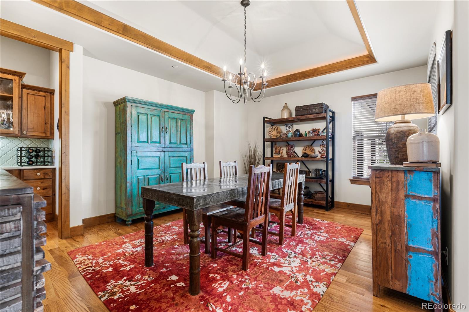 1251 Buffalo Ridge Road Castle Pines, CO 80108 - Photo 17 of 50 a view of a dining room with furniture window and wooden floor