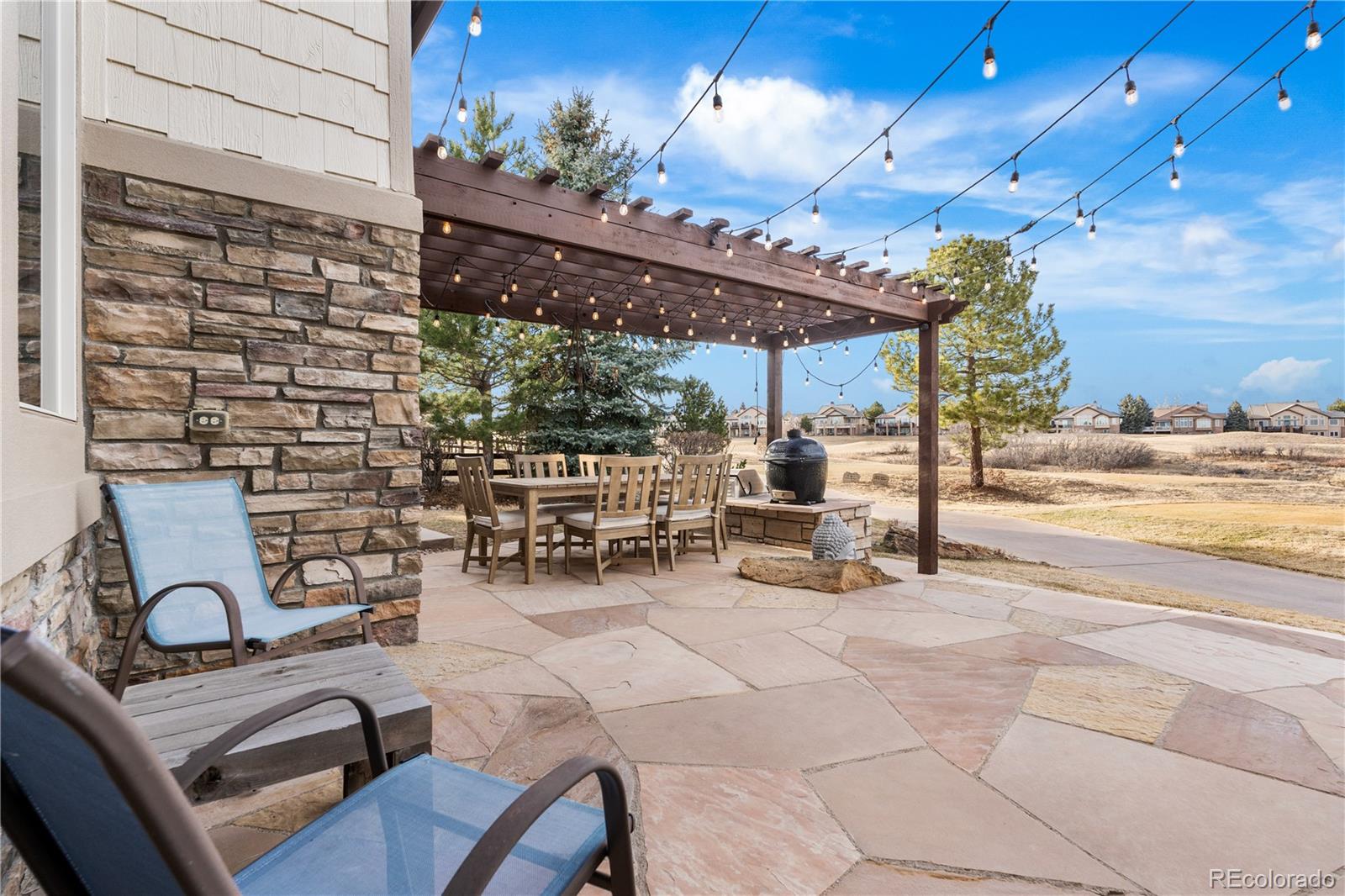 1251 Buffalo Ridge Road Castle Pines, CO 80108 - Photo 21 of 50 a view of a patio with dining table and chairs with a patio