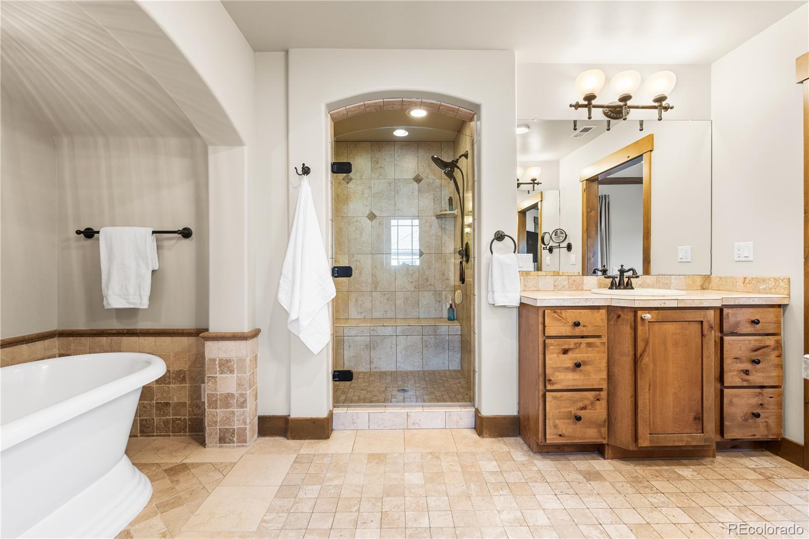 1251 Buffalo Ridge Road Castle Pines, CO 80108 - Photo 29 of 50 a bathroom with a sink a toilet a mirror and shower