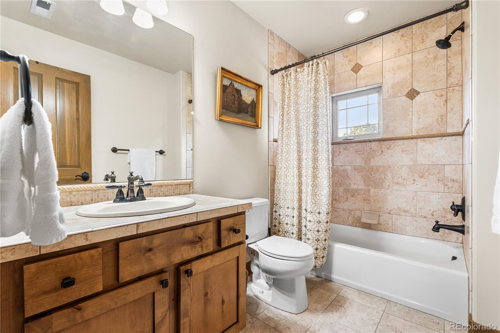 1251 Buffalo Ridge Road Castle Pines, CO 80108 - Photo 33 of 50 a bathroom with a sink a toilet and shower