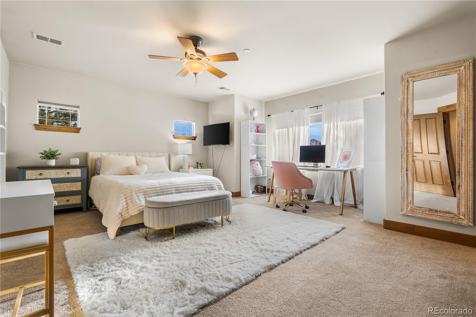 1251 Buffalo Ridge Road Castle Pines, CO 80108 - Photo 36 of 50 a bed room with a bed and a mirror