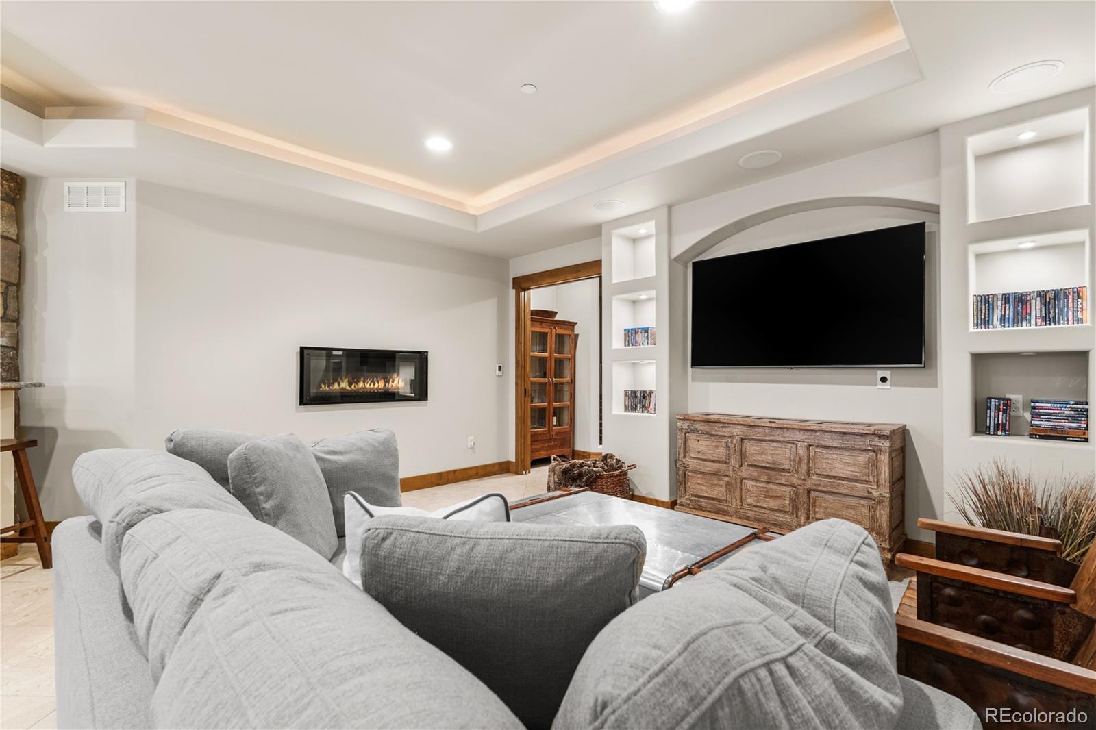 1251 Buffalo Ridge Road Castle Pines, CO 80108 - Photo 39 of 50 a living room with furniture and a flat screen tv