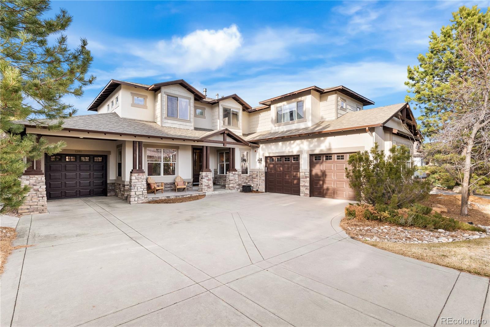 1251 Buffalo Ridge Road Castle Pines, CO 80108 - Photo 50 of 50 a front view of a house with yard and porch