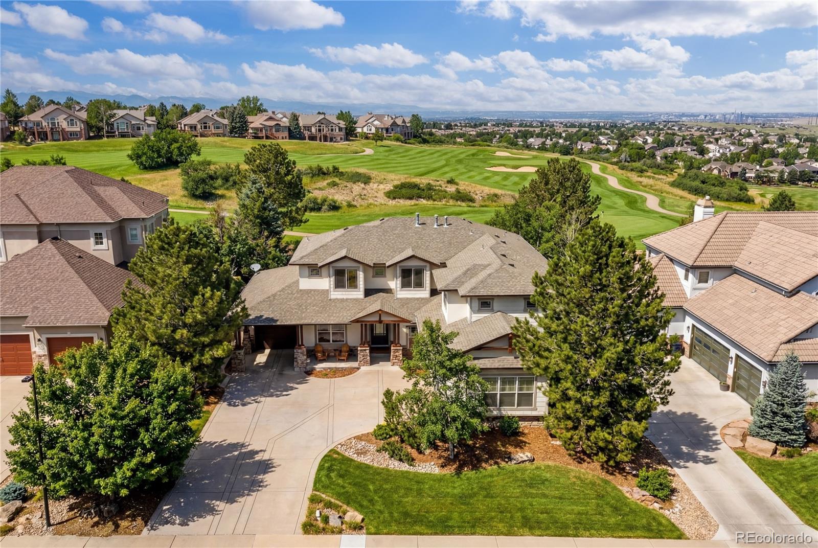 1251 Buffalo Ridge Road Castle Pines, CO 80108 - Photo 5 of 50 an aerial view of a house with a garden