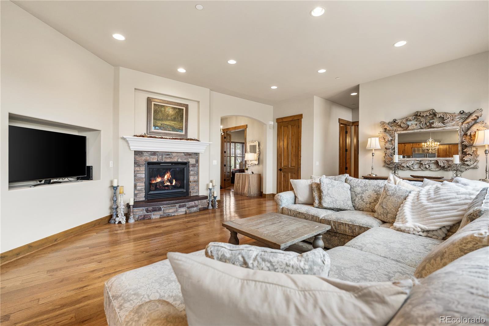1251 Buffalo Ridge Road Castle Pines, CO 80108 - Photo 7 of 50 a living room with furniture and a fireplace
