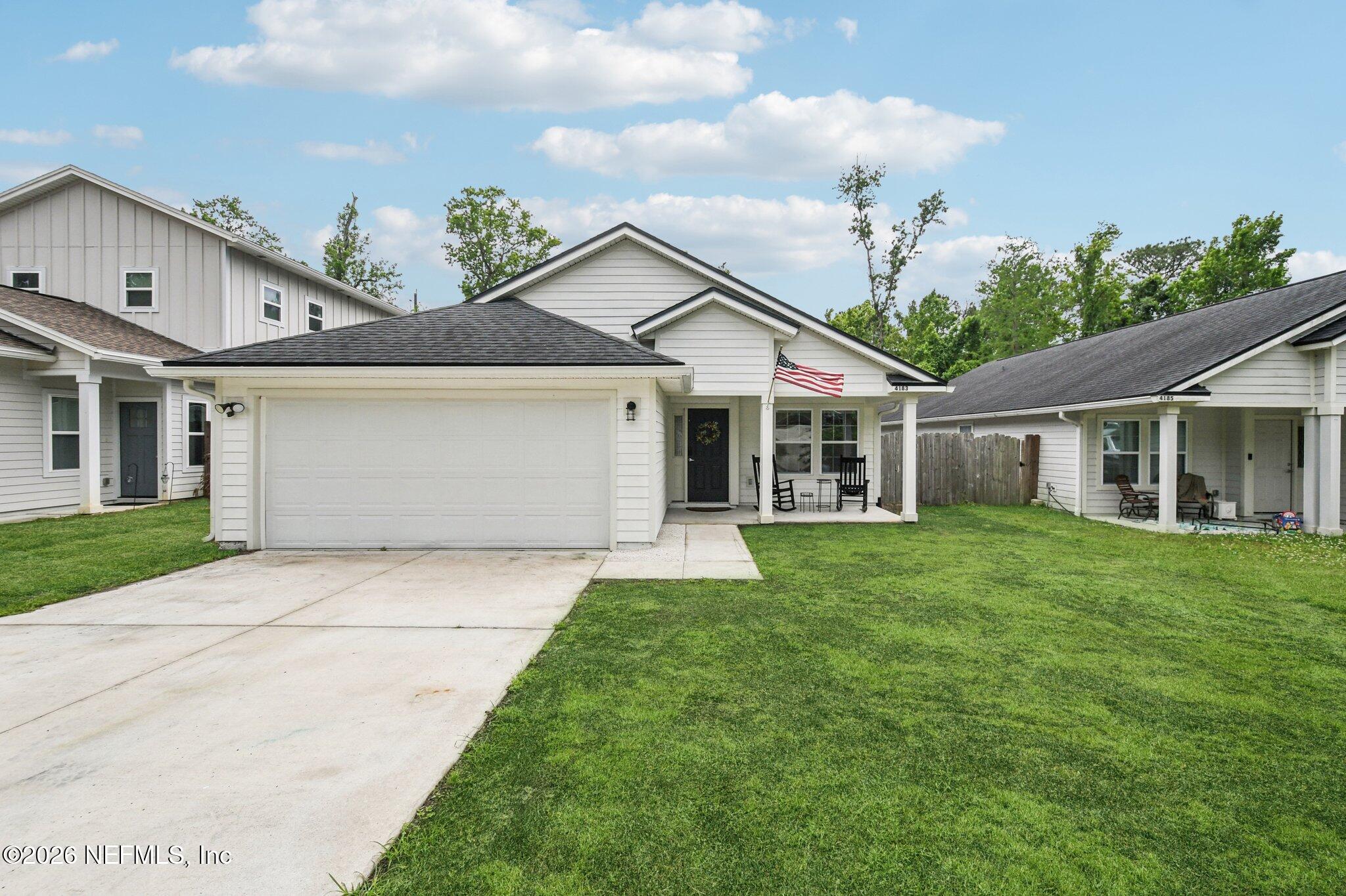 a front view of a house with a garden and yard