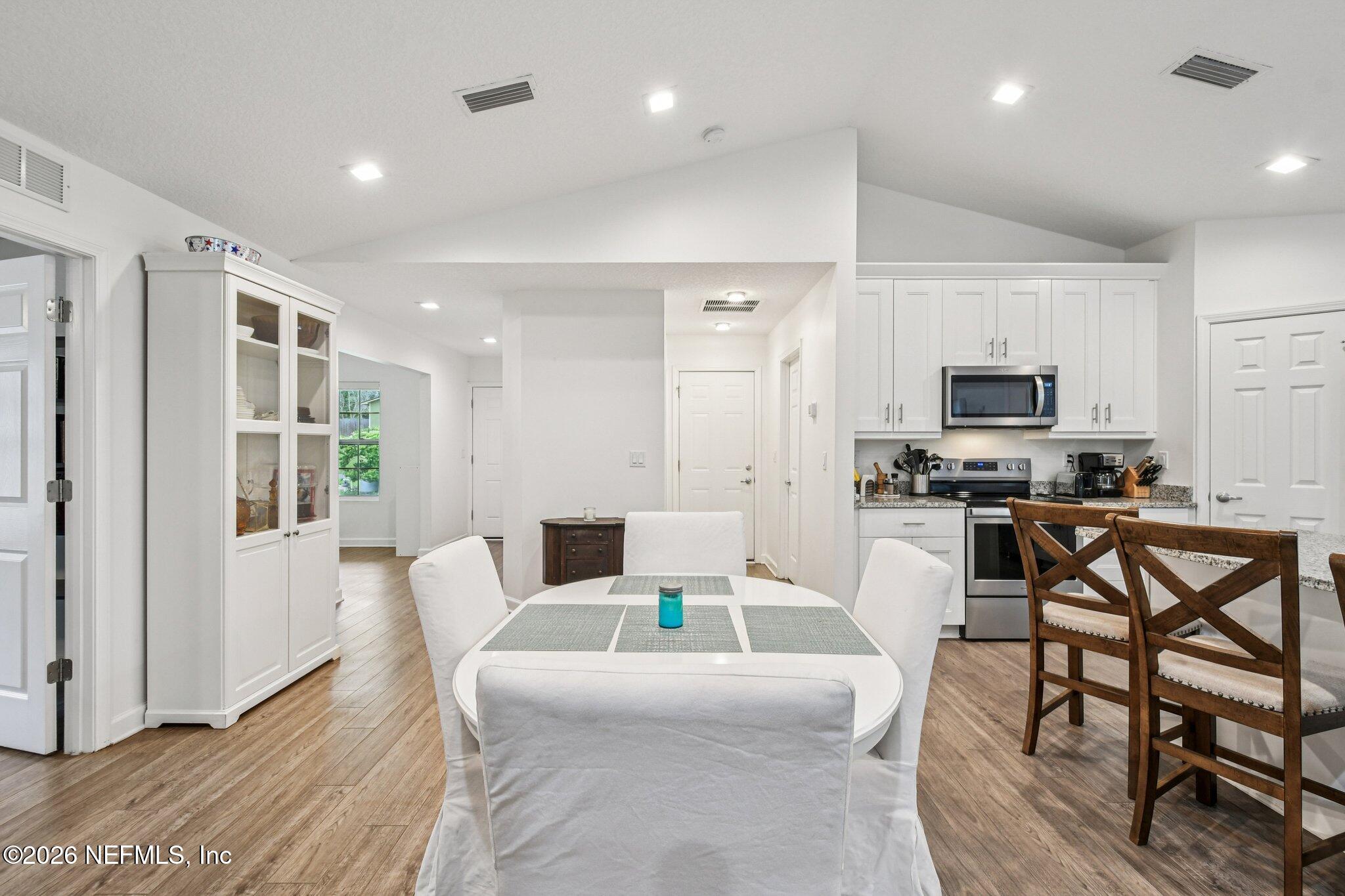4183 Pine Road Orange Park, FL 32065 - Photo 13 of 62 a living room with furniture a flat screen tv and kitchen view