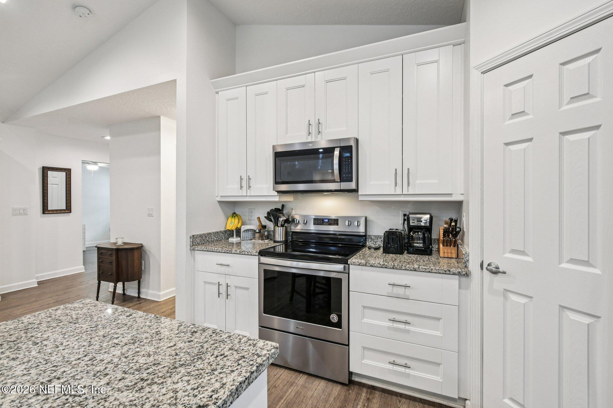 4183 Pine Road Orange Park, FL 32065 - Photo 23 of 62 a kitchen with stainless steel appliances granite countertop a stove and cabinets