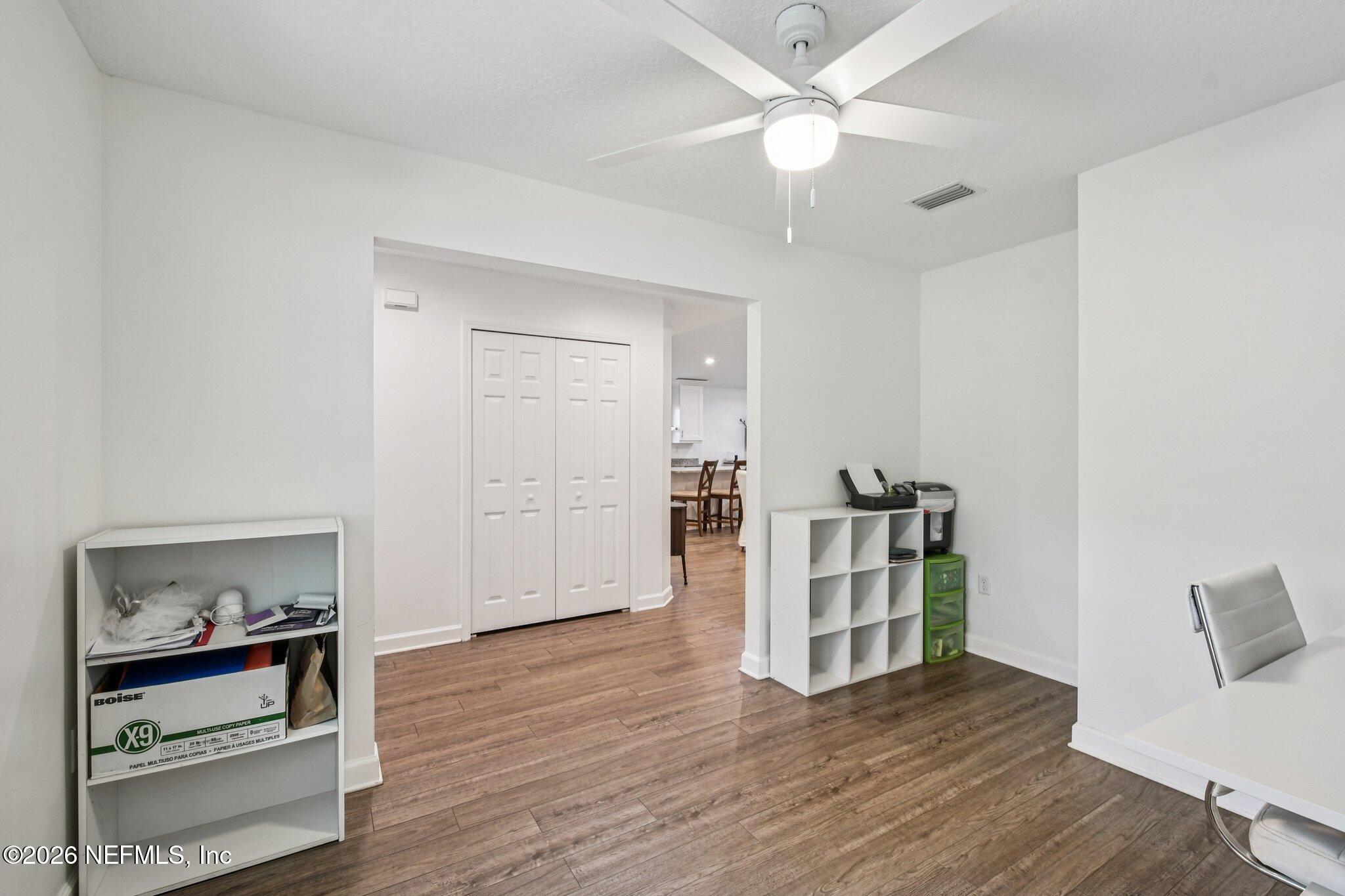 4183 Pine Road Orange Park, FL 32065 - Photo 25 of 62 a view of a livingroom with wooden floor and a ceiling fan