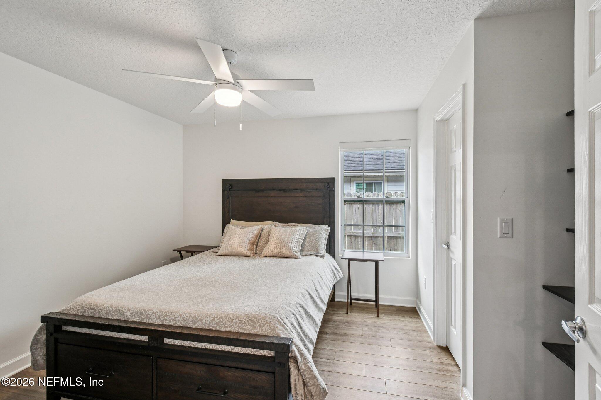 4183 Pine Road Orange Park, FL 32065 - Photo 27 of 62 a bedroom with a bed and a chandelier