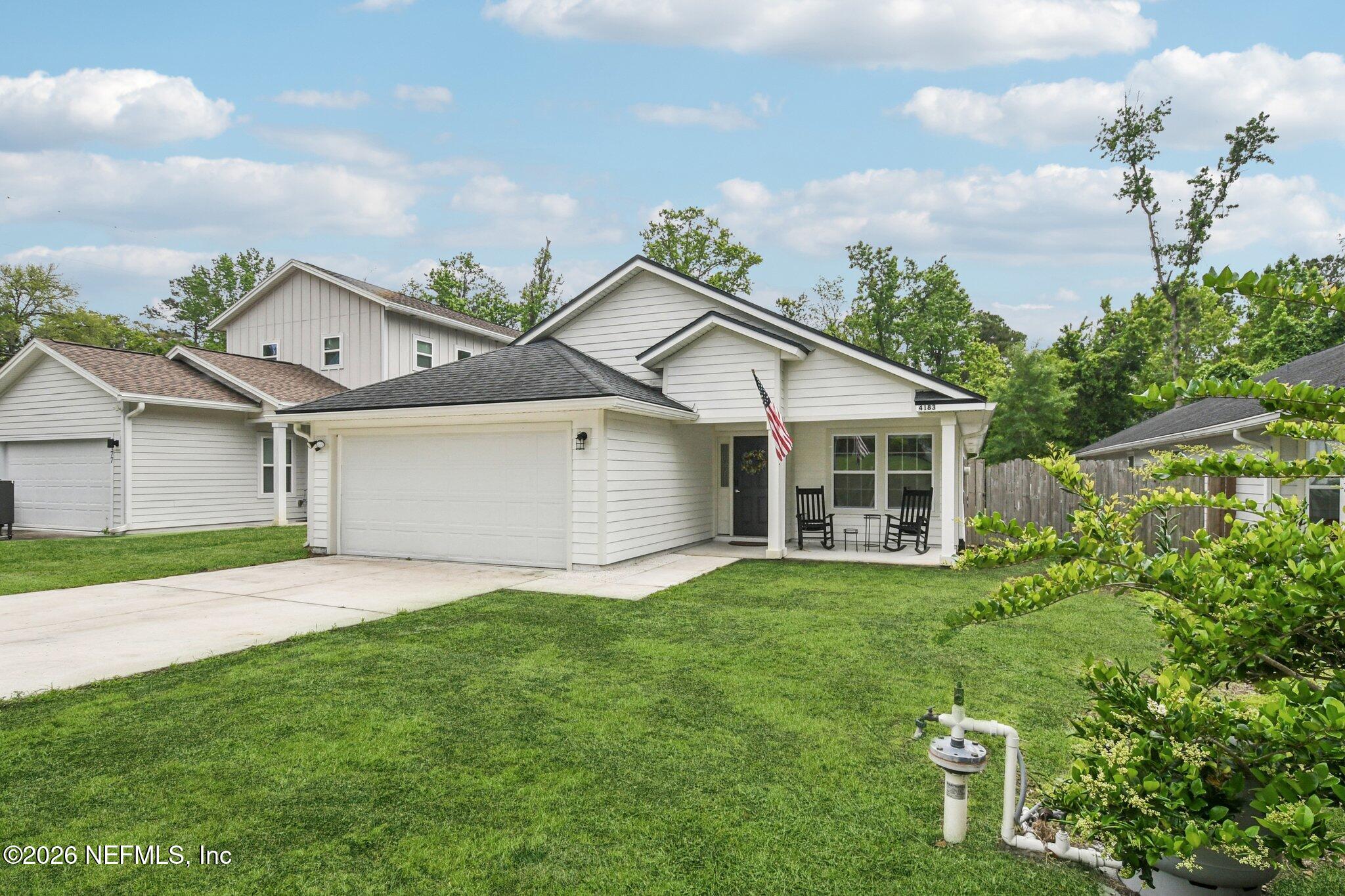 4183 Pine Road Orange Park, FL 32065 - Photo 3 of 62 a front view of a house with a yard and garage