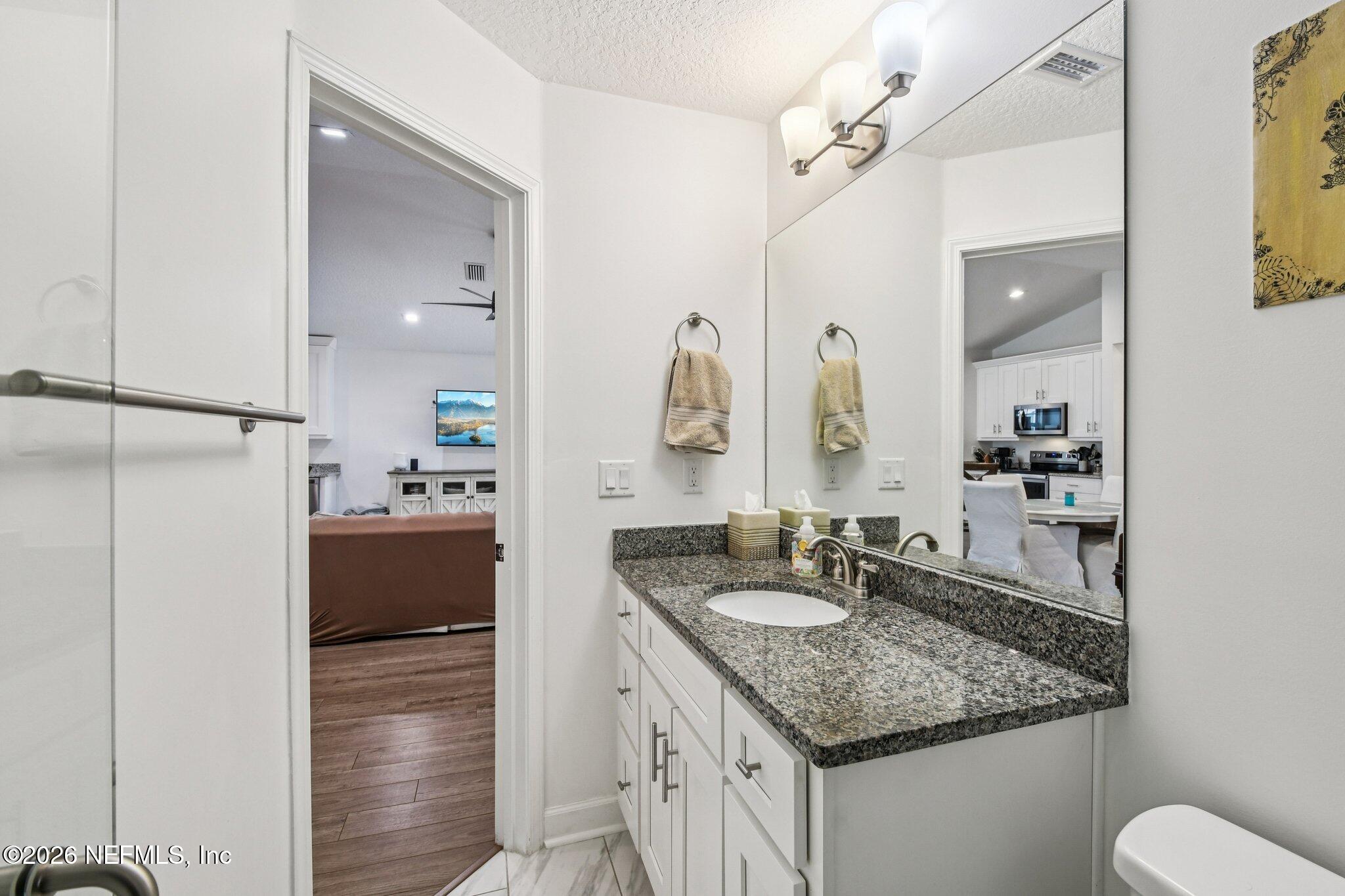 4183 Pine Road Orange Park, FL 32065 - Photo 32 of 62 a bathroom with a granite countertop sink and a mirror