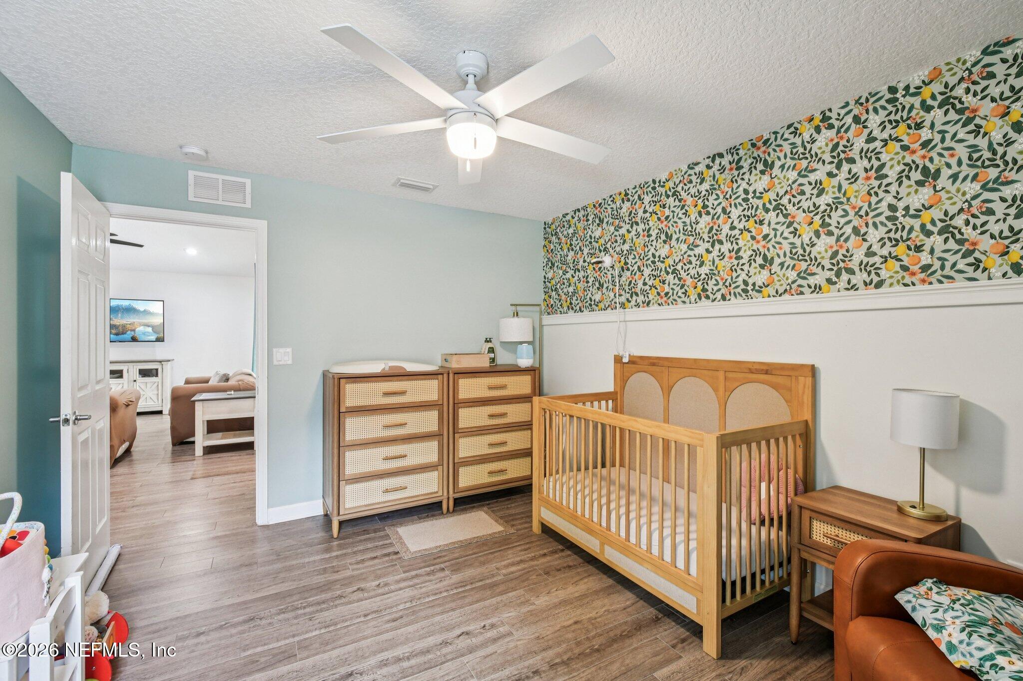 4183 Pine Road Orange Park, FL 32065 - Photo 34 of 62 a bedroom that has a bed and a chair in it